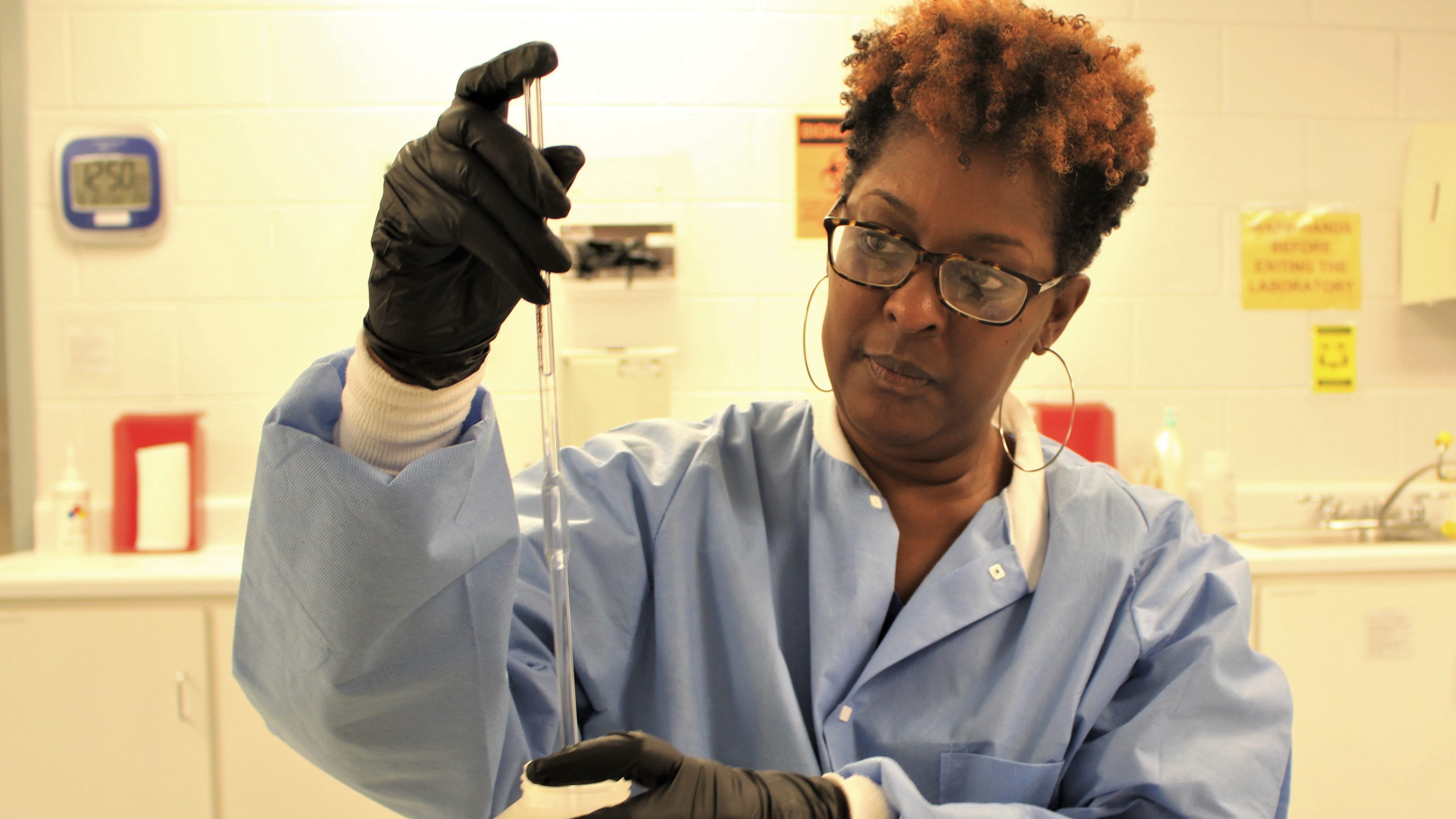 A technician readies a sample for testing in the COBRATF’s blood lab.